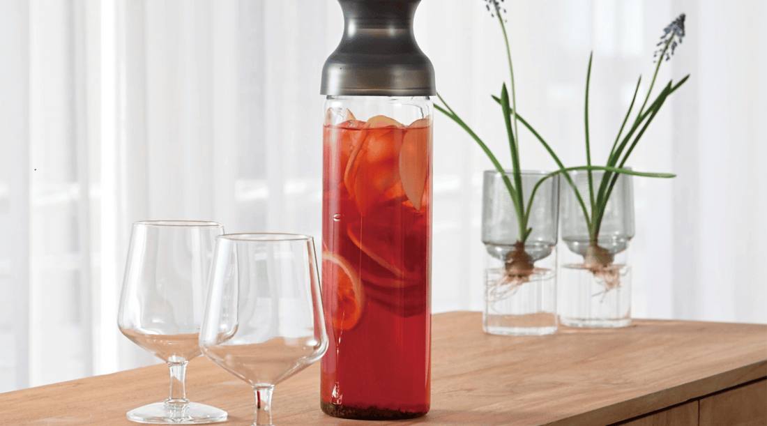 ced coffee in a clear glass”: A view of a coffee-filled glass with ice cubes, highlighting its cooling effect