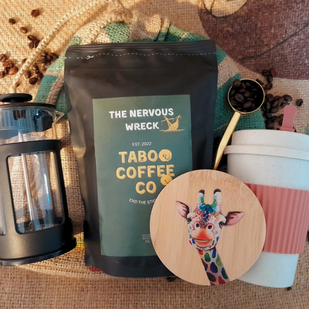 the ultimate coffee gift set with a bag of coffee, a cafetiere, a reuseable coffee mug, a giraffe wooden coaster and a reusable hessian gift sack