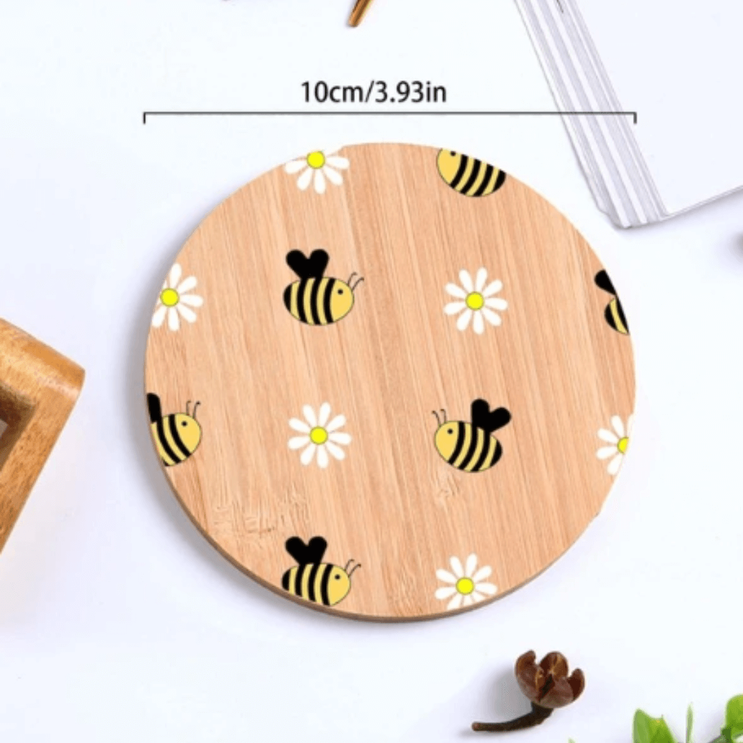 A wooden coffee coaster with a bee design