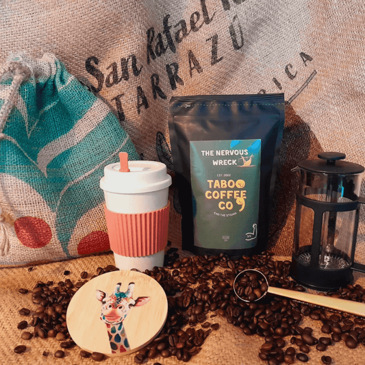 the ultimate coffee gift set with a bag of coffee, a cafetiere, a reuseable coffee mug, a giraffe wooden coaster and a reusable hessian gift sack
